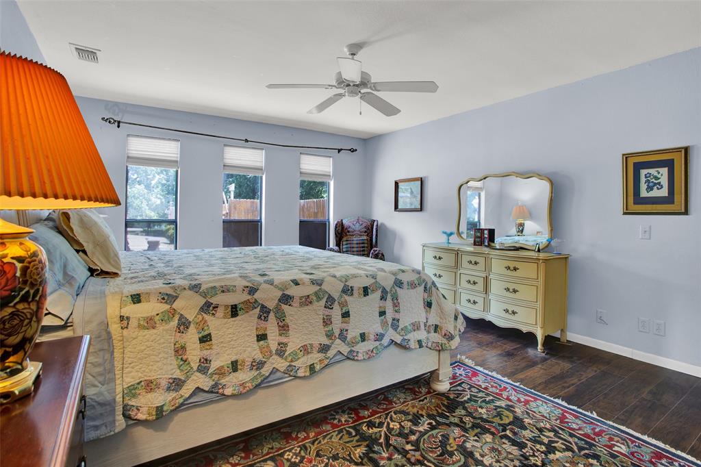 7146 Refuge Road Pottsboro, TX 75076 - Photo 32 of 39 a bedroom with a bed and wooden floor