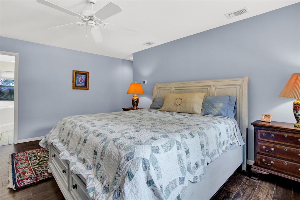 7146 Refuge Road Pottsboro, TX 75076 - Photo 33 of 39 a bedroom with a bed and wooden floor