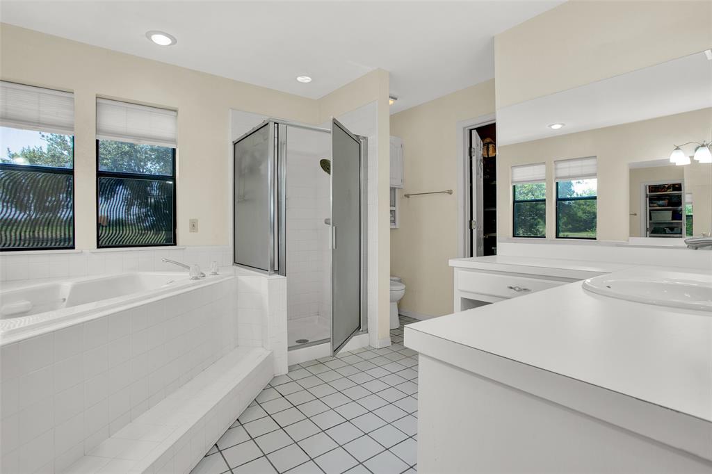 7146 Refuge Road Pottsboro, TX 75076 - Photo 34 of 39 a bathroom with a tub a sink and a large mirror