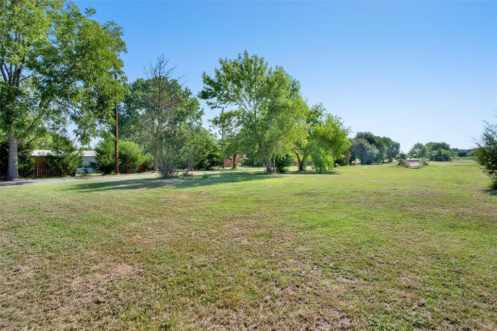 7146 Refuge Road Pottsboro, TX 75076 - Photo 10 of 39 a view of a green field with wooden fence