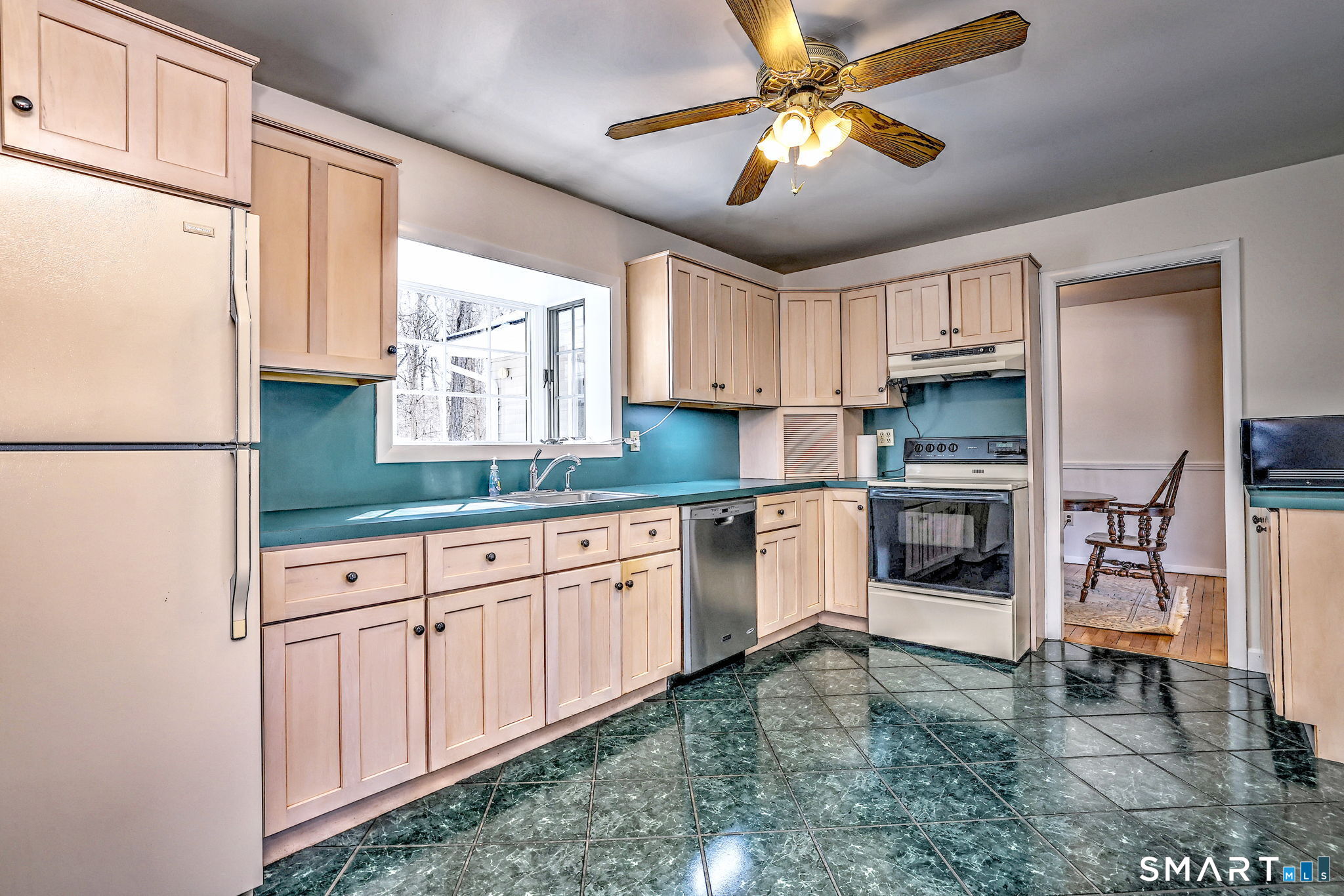 30 Crestview Terrace Wallingford, CT 06492 - Photo 11 of 32 a kitchen with granite countertop a refrigerator a sink a stove and white cabinets