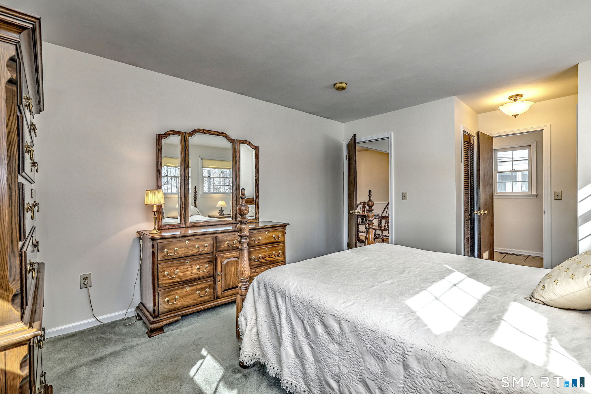 30 Crestview Terrace Wallingford, CT 06492 - Photo 21 of 32 a bedroom with a bed and dresser with mirror