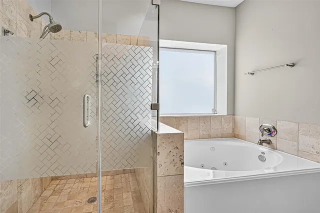 a bathroom with a bathtub and a shower