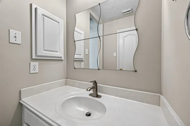 a bathroom with a sink and mirror