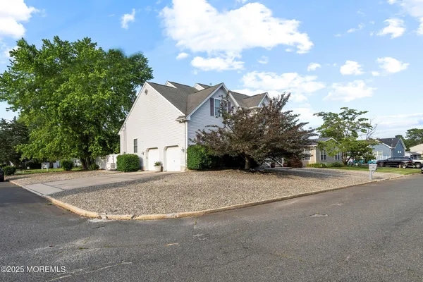 a view of a house with a yard and garage