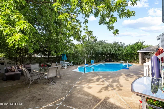 a view of a backyard with swimming pool