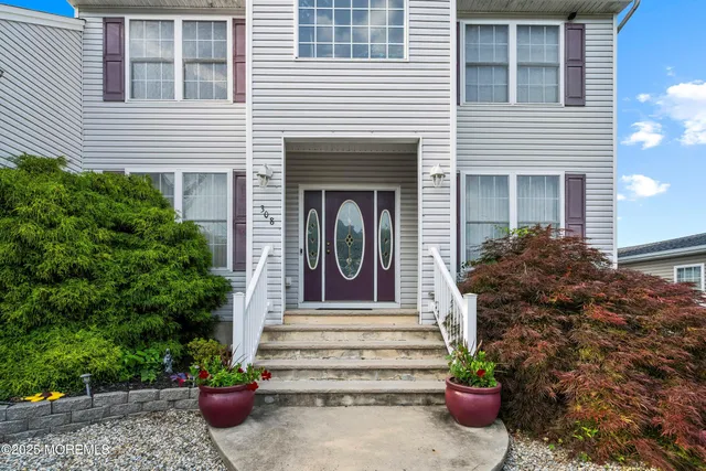 a view of a house with potted plants