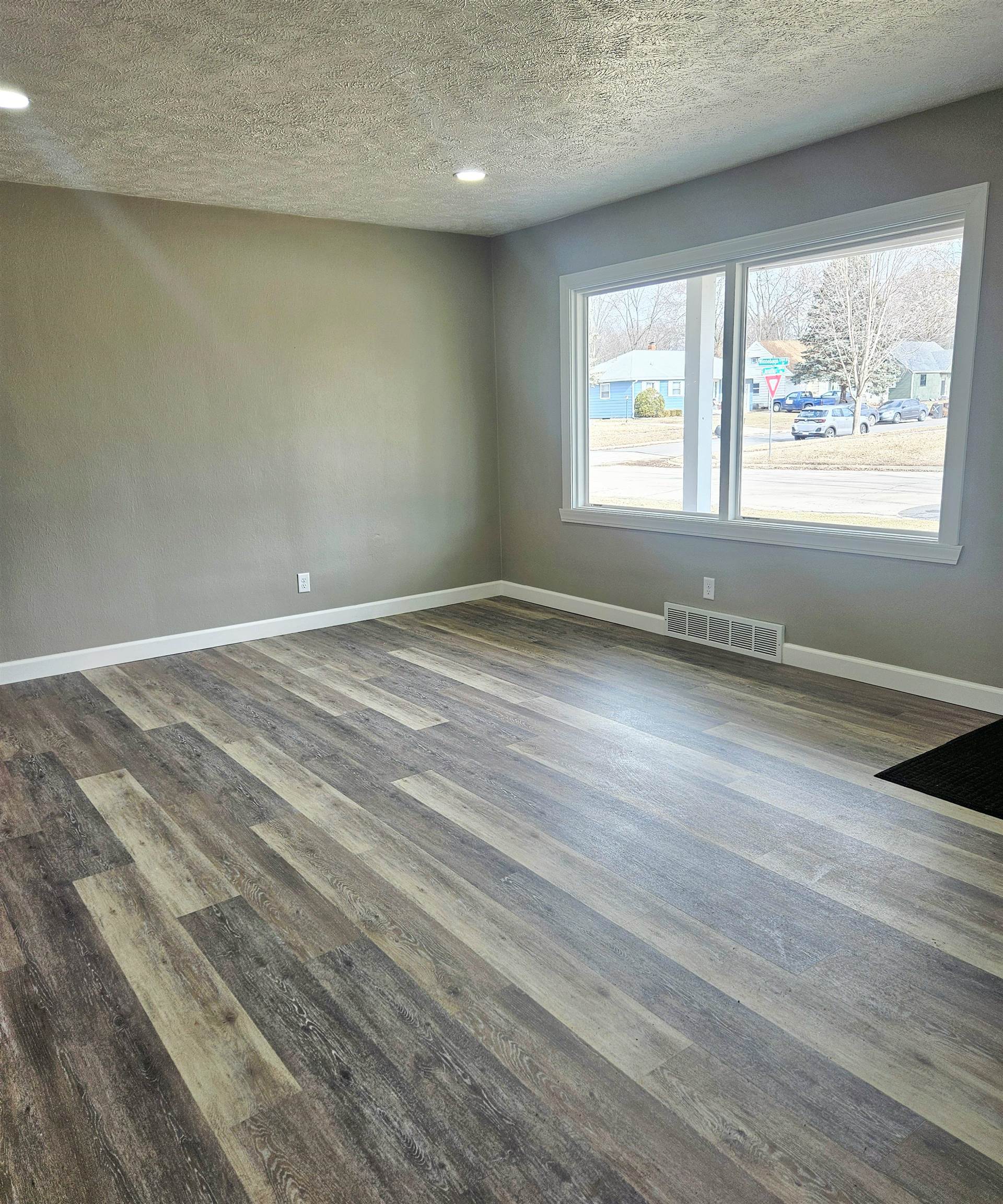 3216 North Winnebago Street Rockford, IL 61103 - Photo 3 of 18 an empty room with wooden floor and windows