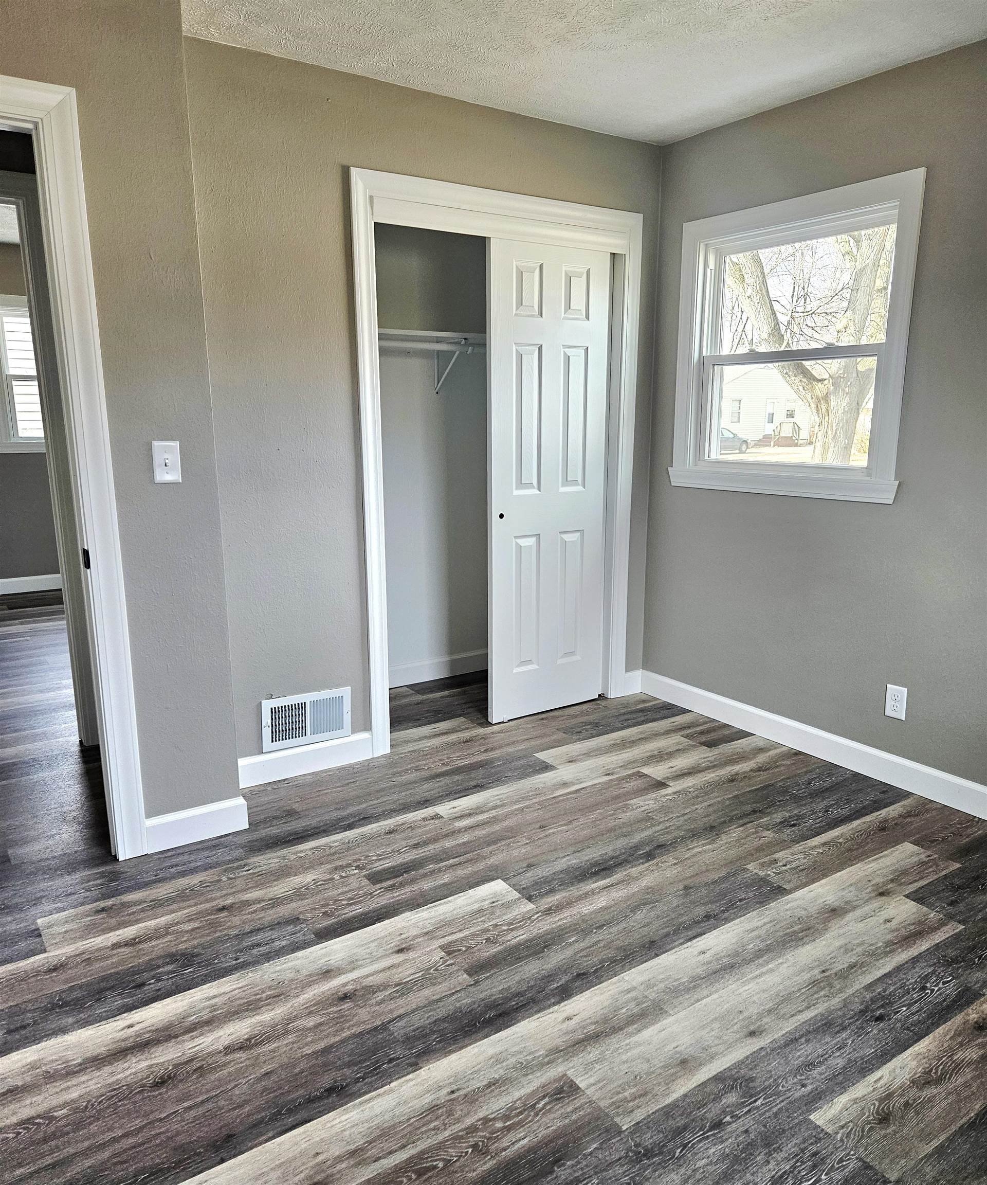 3216 North Winnebago Street Rockford, IL 61103 - Photo 5 of 18 a view of a livingroom with wooden floor and window