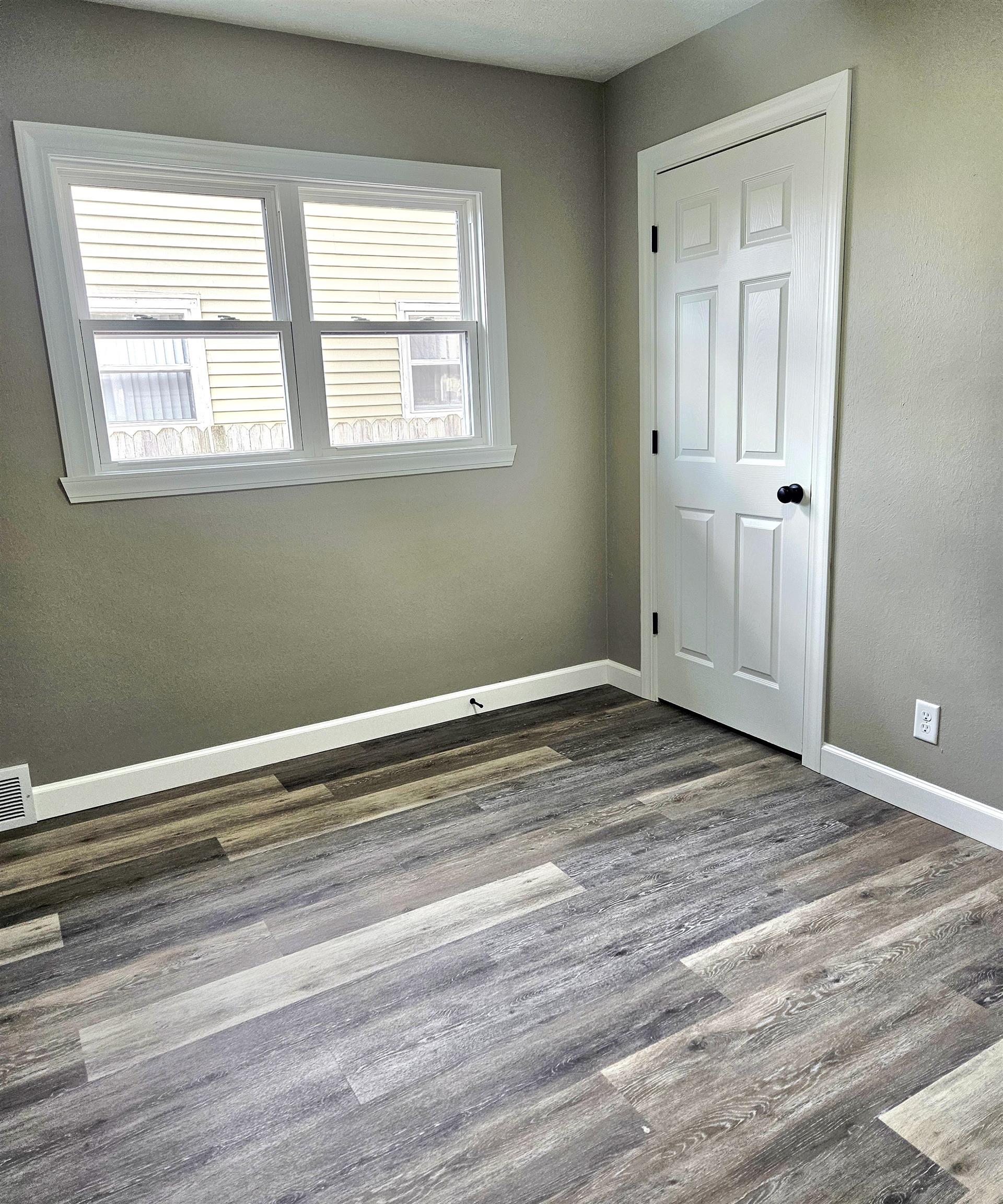 3216 North Winnebago Street Rockford, IL 61103 - Photo 9 of 18 a view of a room with wooden floor and windows
