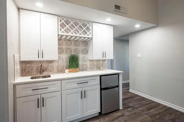 a view of empty room with wooden floor and window