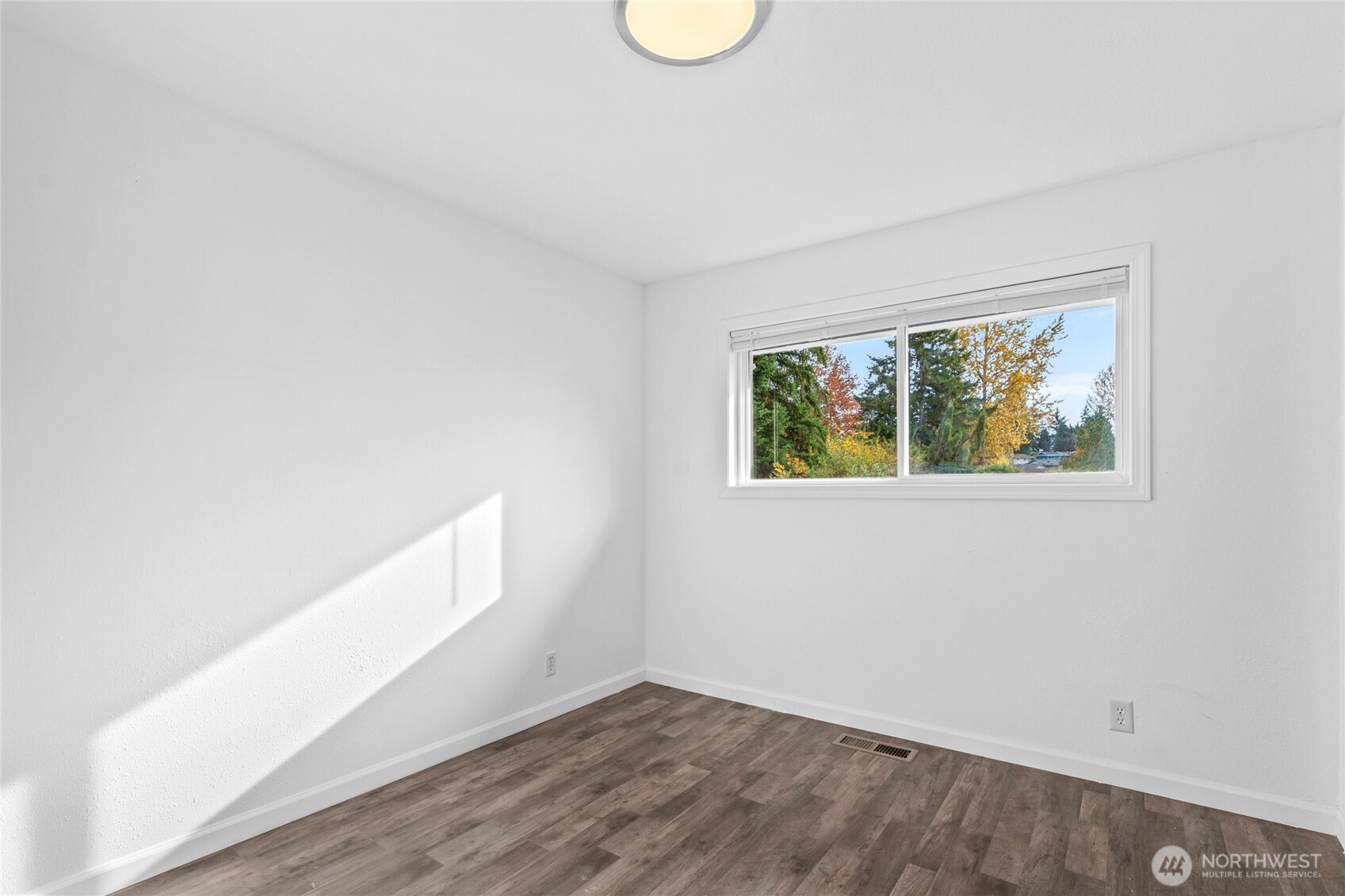 12703 Southeast 163rd Street Renton, WA 98058 - Photo 13 of 21 an empty room with wooden floor and window