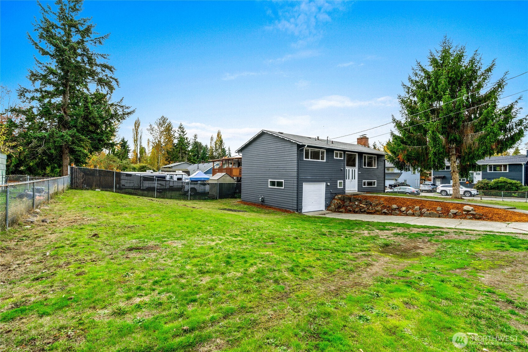 12703 Southeast 163rd Street Renton, WA 98058 - Photo 3 of 21 a view of a house with a big yard potted plants and large tree