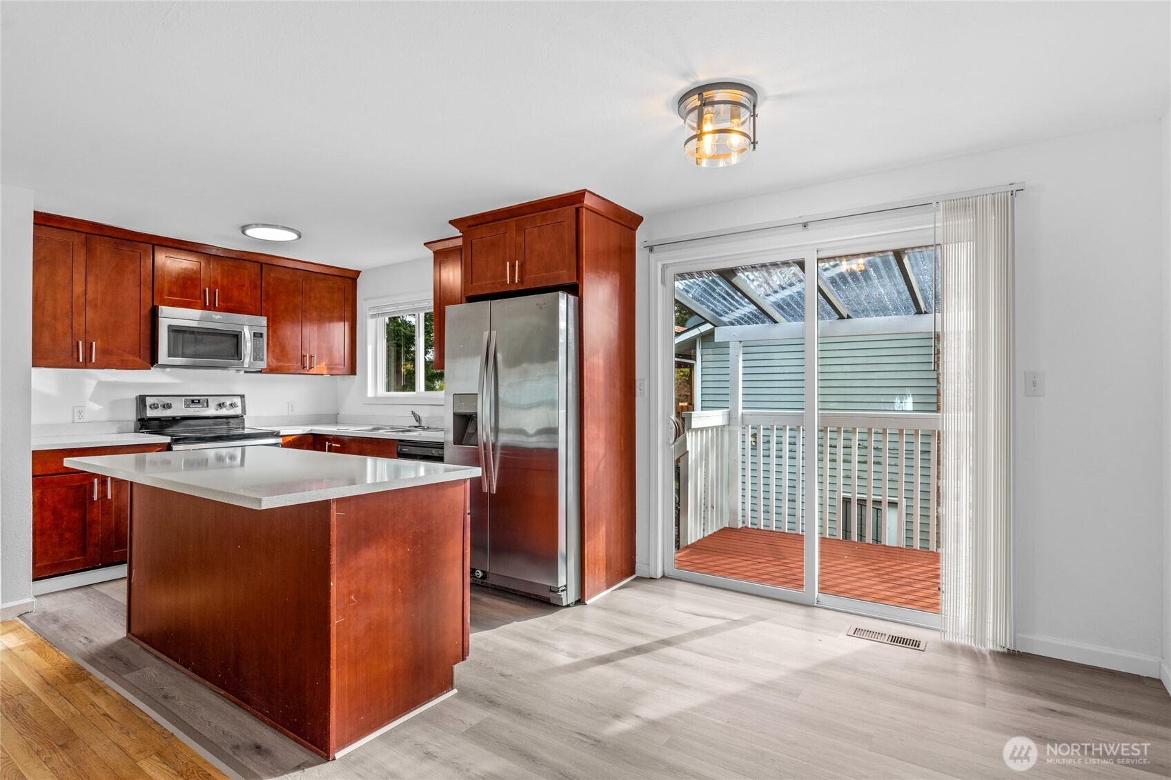 12703 Southeast 163rd Street Renton, WA 98058 - Photo 7 of 21 a kitchen with stainless steel appliances granite countertop a refrigerator a stove top oven a sink and dishwasher