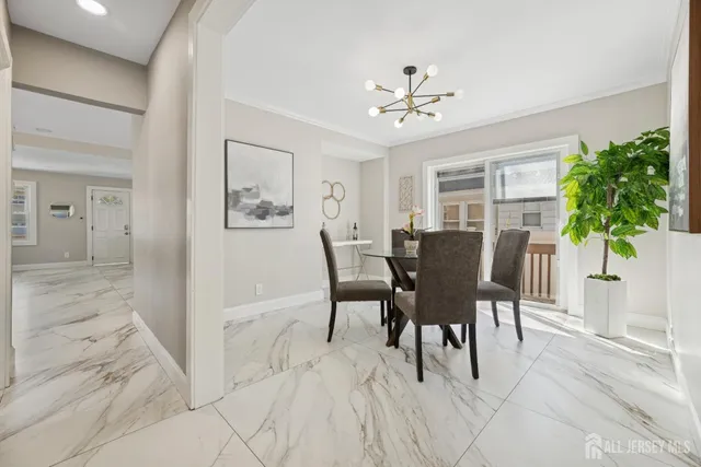 a view of a dining room with furniture and a potted plant