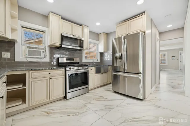 a kitchen with stainless steel appliances a refrigerator sink and microwave