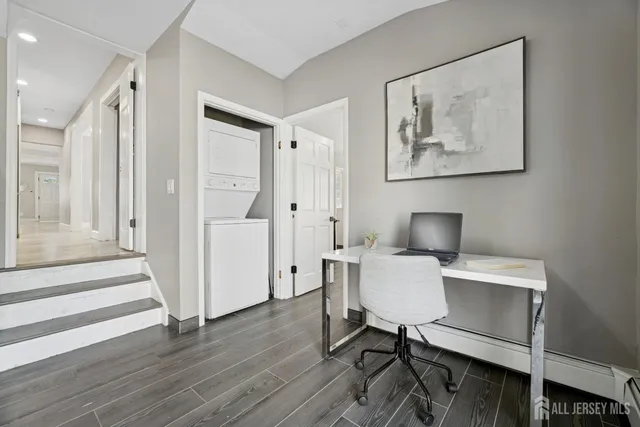 a view of a workspace with furniture and wooden floor