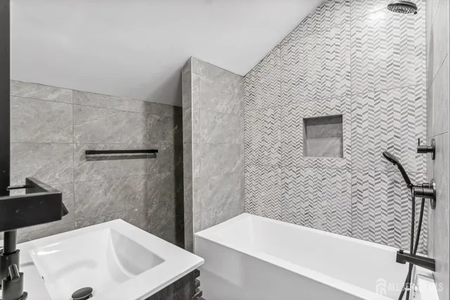 a bathroom with a sink a bathtub and shower