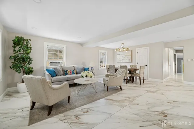 a living room with furniture potted plant and a window