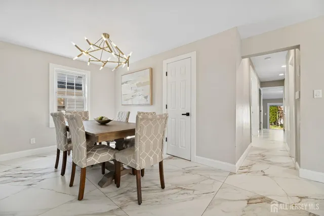 a view of a dining room with furniture and chandelier