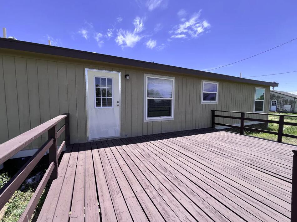 107 Grant Street Smyer, TX 79367 - Photo 21 of 22 a balcony with wooden floor table and chairs