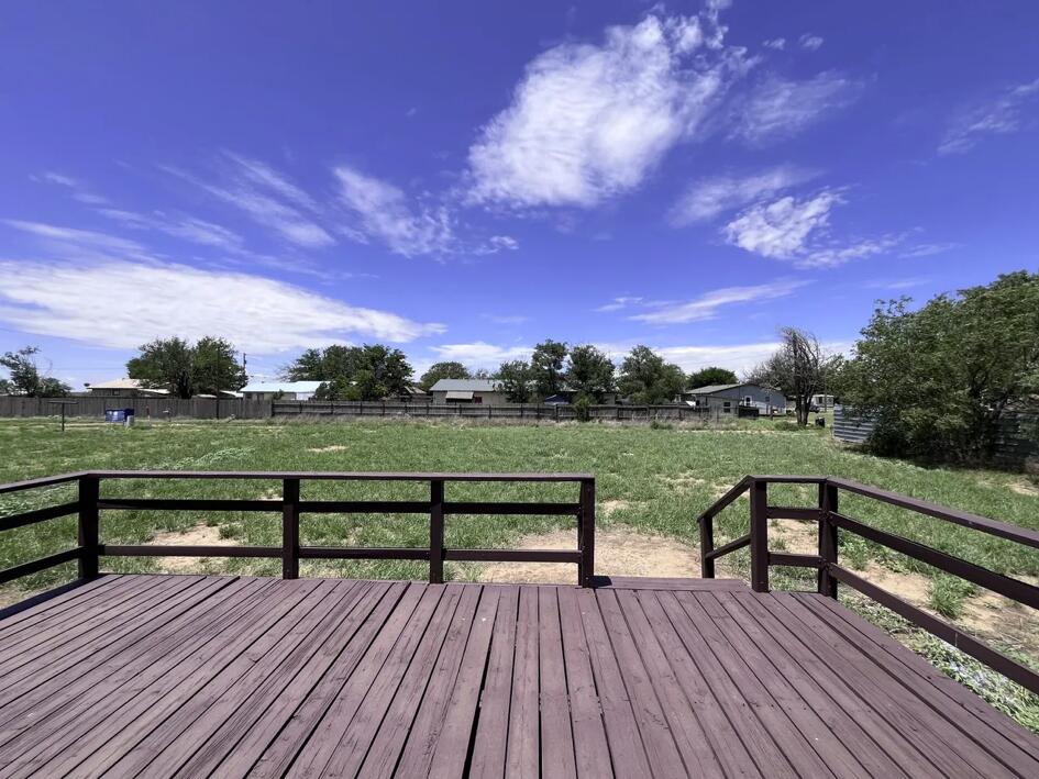 107 Grant Street Smyer, TX 79367 - Photo 22 of 22 a view of a wooden deck with a yard