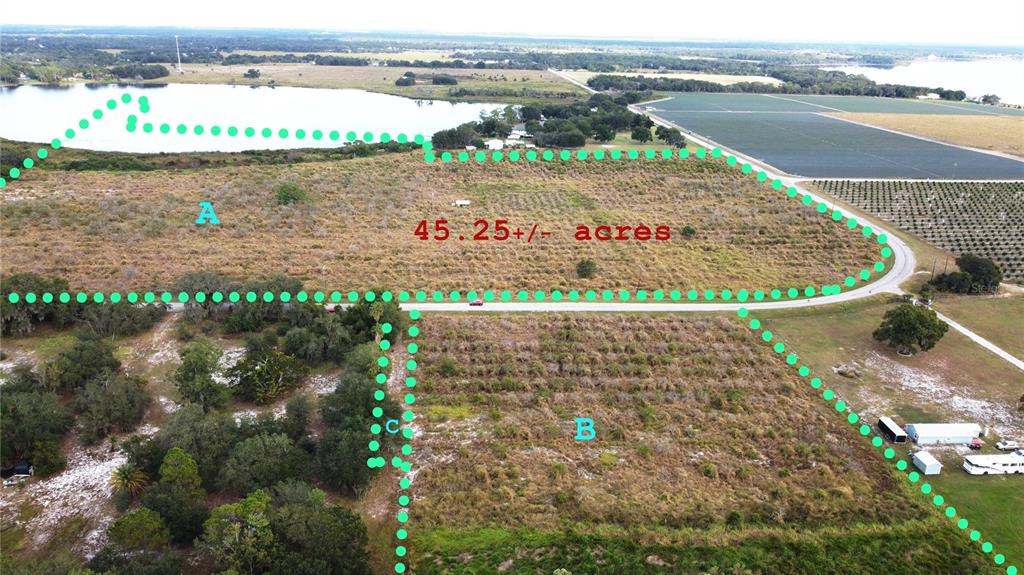 an aerial view of beach and residential houses with outdoor space