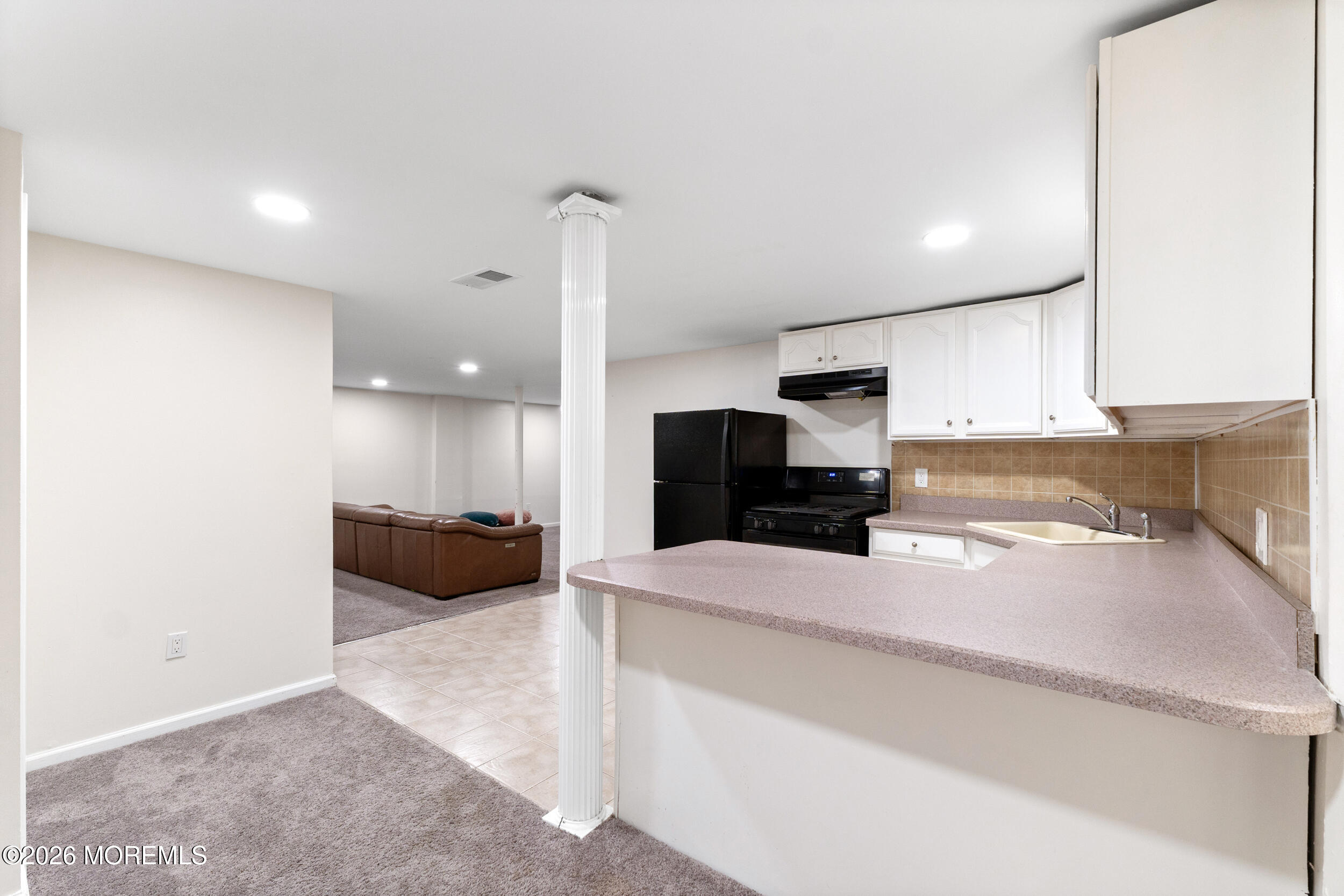 104 Autumn Road Matawan, NJ 07747 - Photo 46 of 64 a large kitchen with a large counter top appliances and cabinets
