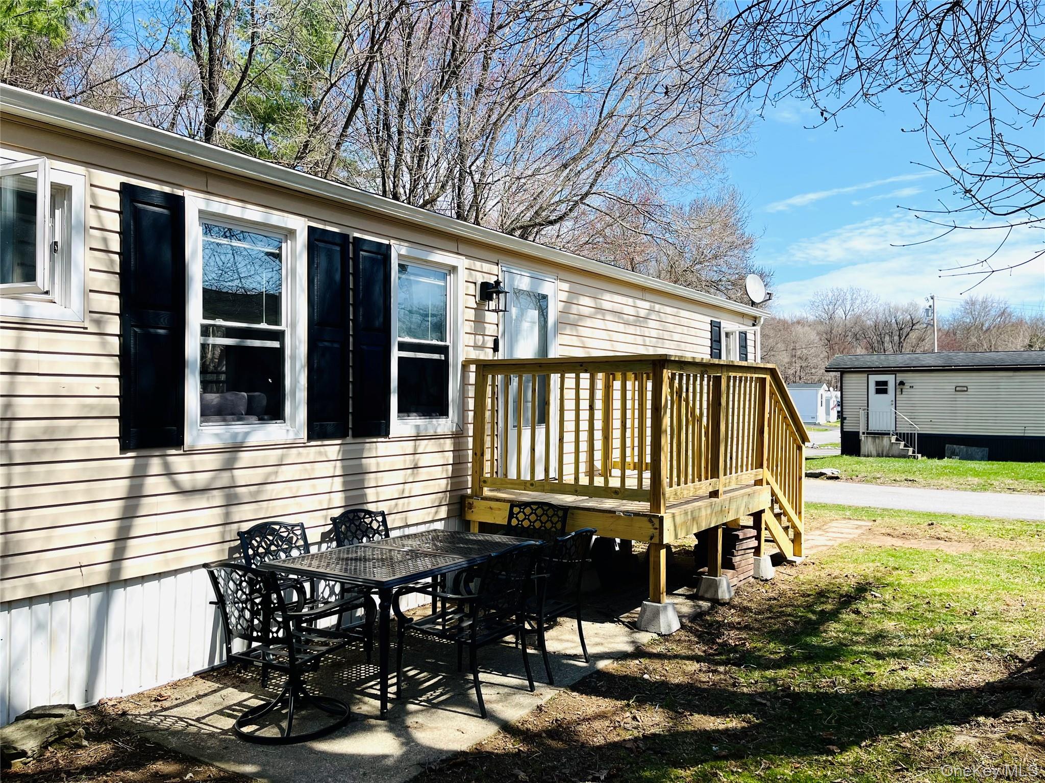 723 Beekman Road, Unit 42 Hopewell Junction, NY 12533 - Photo 2 of 16 a view of a house with pool and sitting area
