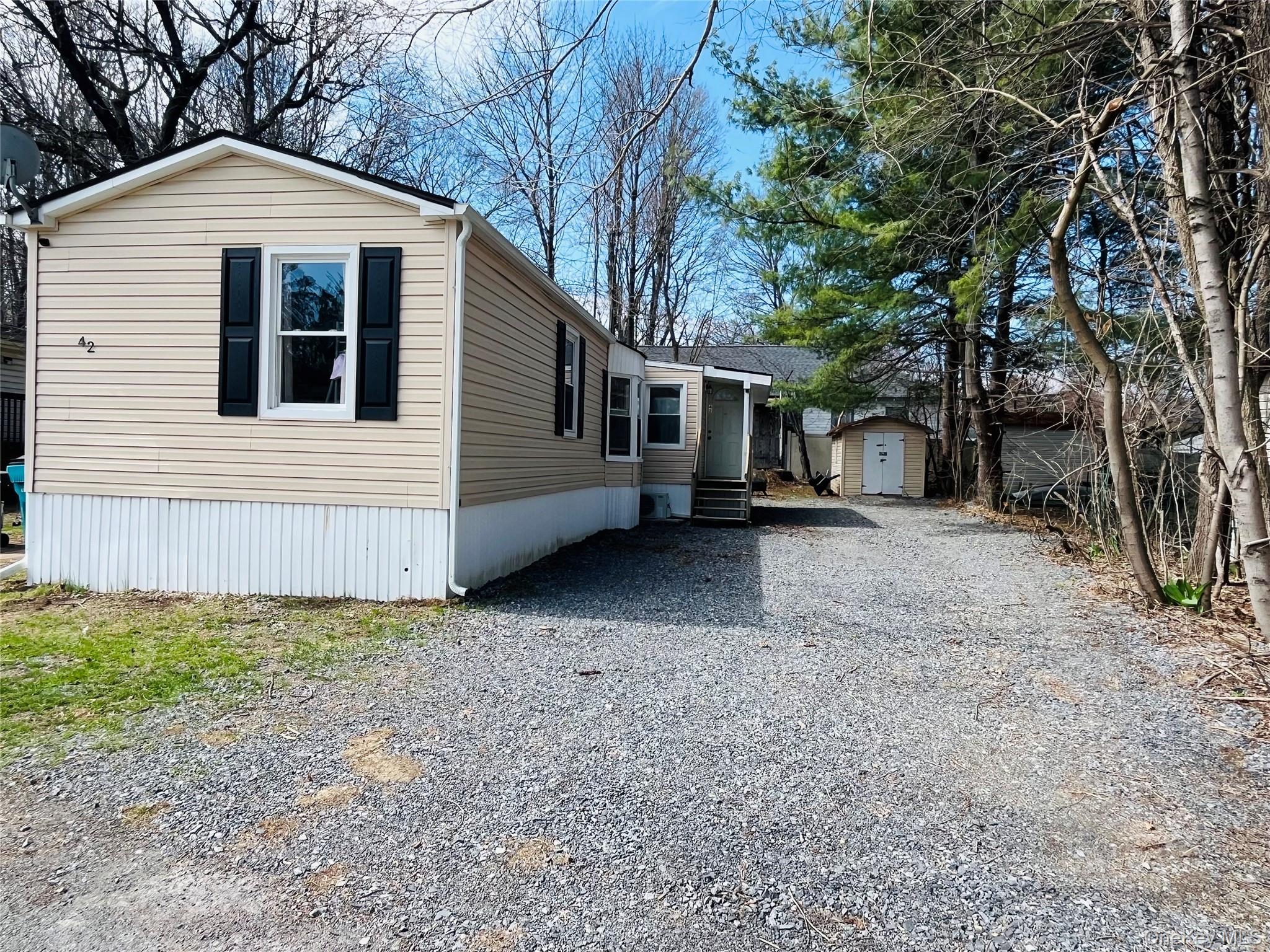 723 Beekman Road, Unit 42 Hopewell Junction, NY 12533 - Photo 6 of 16 a view of a house with a yard