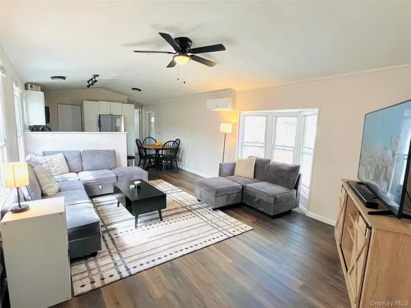 a kitchen with granite countertop a stove top oven a sink dishwasher a dining table and chairs with wooden floor