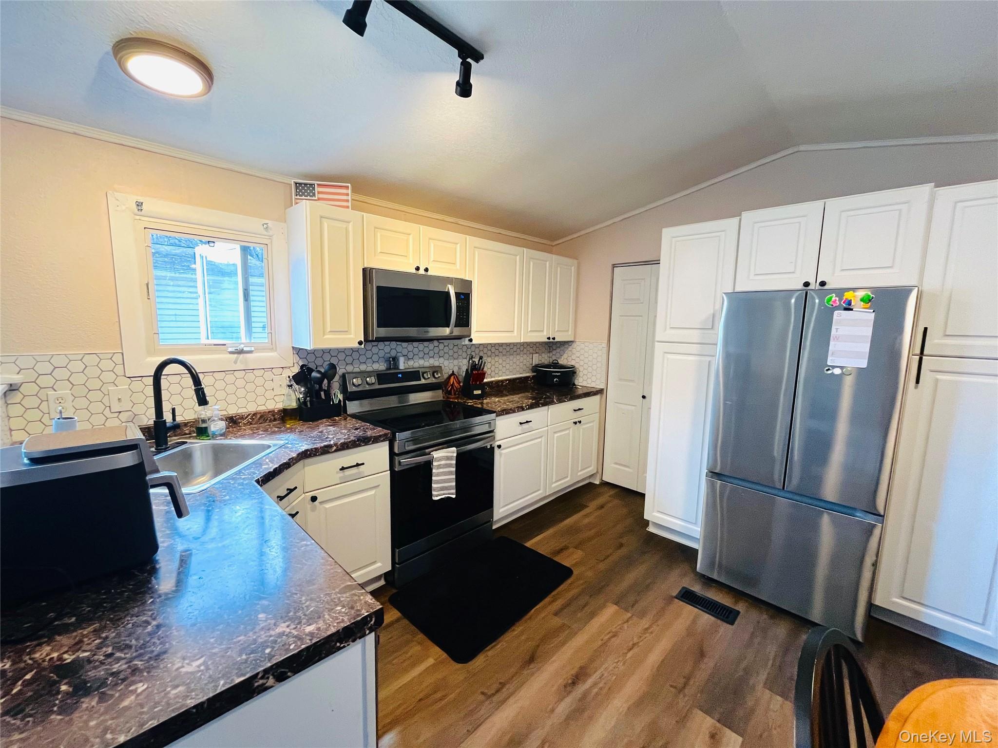 723 Beekman Road, Unit 42 Hopewell Junction, NY 12533 - Photo 9 of 16 a kitchen with granite countertop a refrigerator stove top oven and sink