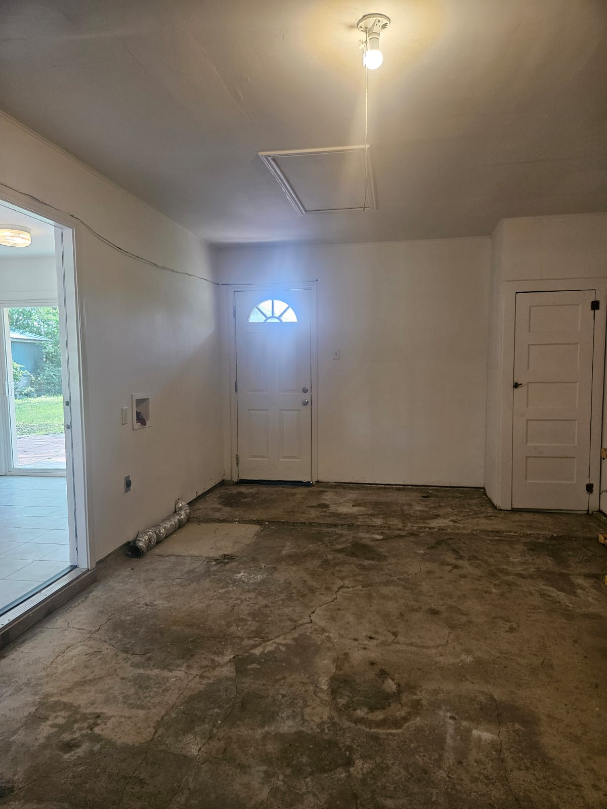 1401 Trinity Street Lockhart, TX 78644 - Photo 22 of 31 Interior space featuring a white painted door with an arched window, a secondary white door, and a sliding glass door