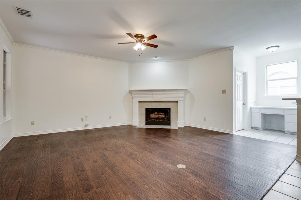 3600 Leighton Ridge Drive Plano, TX 75025 - Photo 16 of 38 a view of an empty room with wooden floor fireplace and a window
