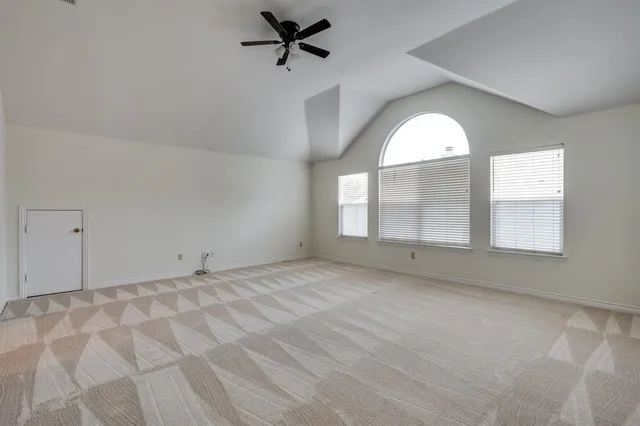 a view of a livingroom with a ceiling fan and window