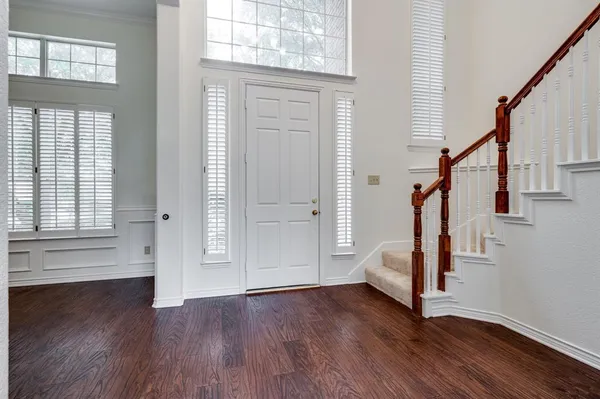 a view of entryway with wooden floor and stairs