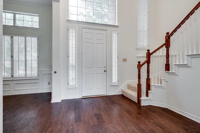 a view of entryway with wooden floor and stairs