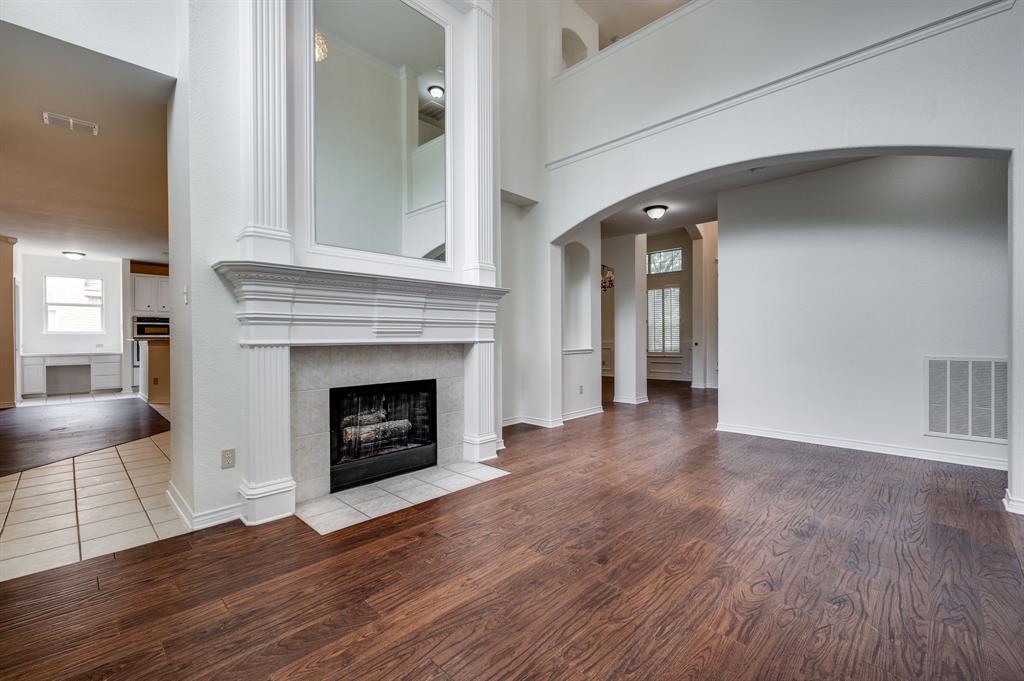 3600 Leighton Ridge Drive Plano, TX 75025 - Photo 10 of 38 a view of an empty room with wooden floor and a fireplace