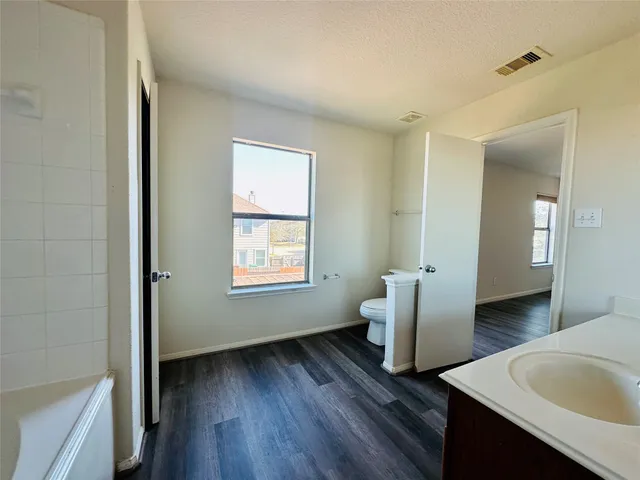 a view of room with window and wooden floor