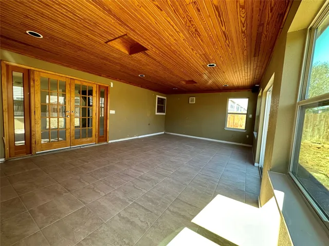 a view of an empty room with large windows