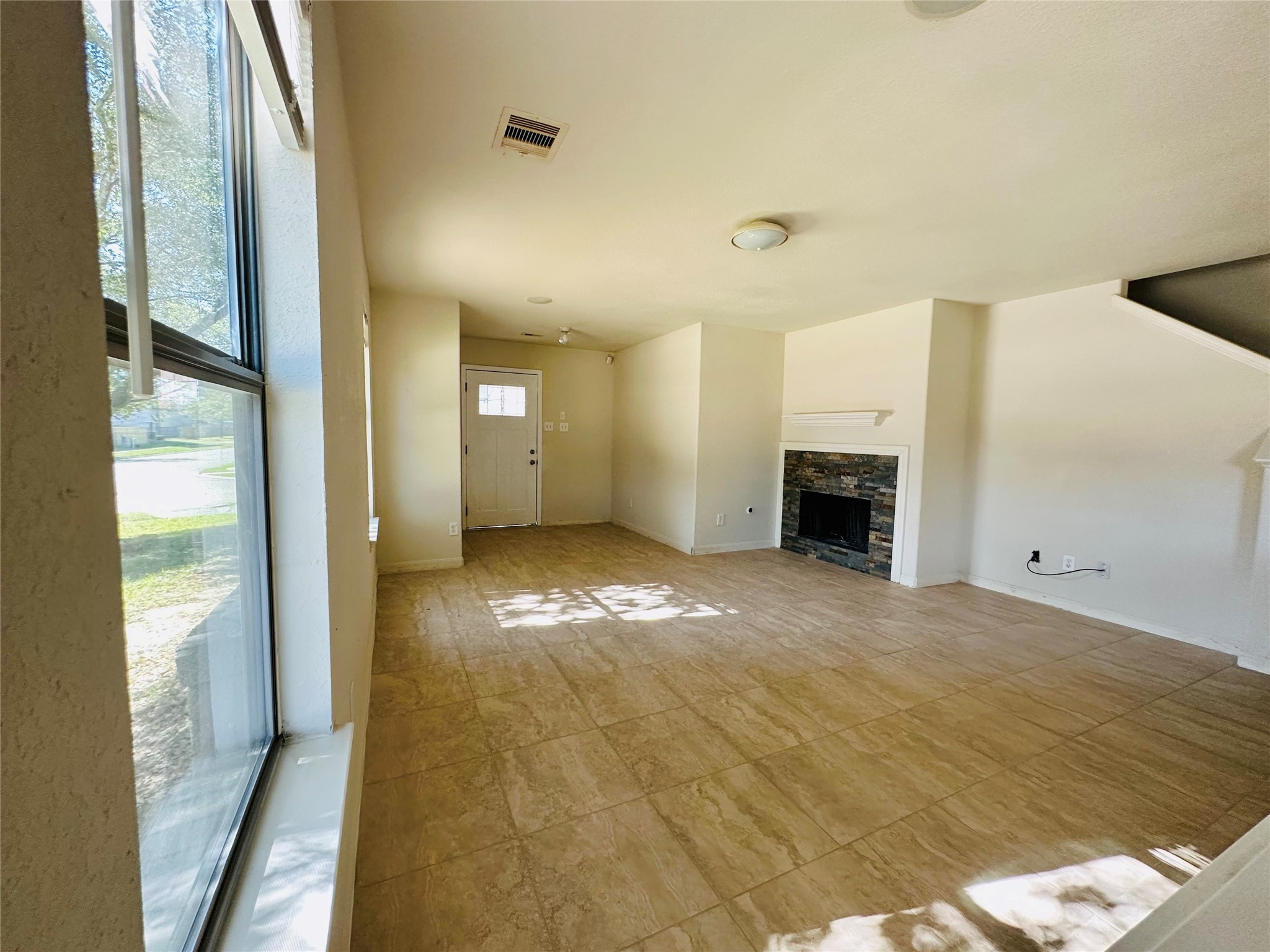 6602 Providence View Lane Houston, TX 77049 - Photo 6 of 17 a view of empty room with wooden floor and fireplace