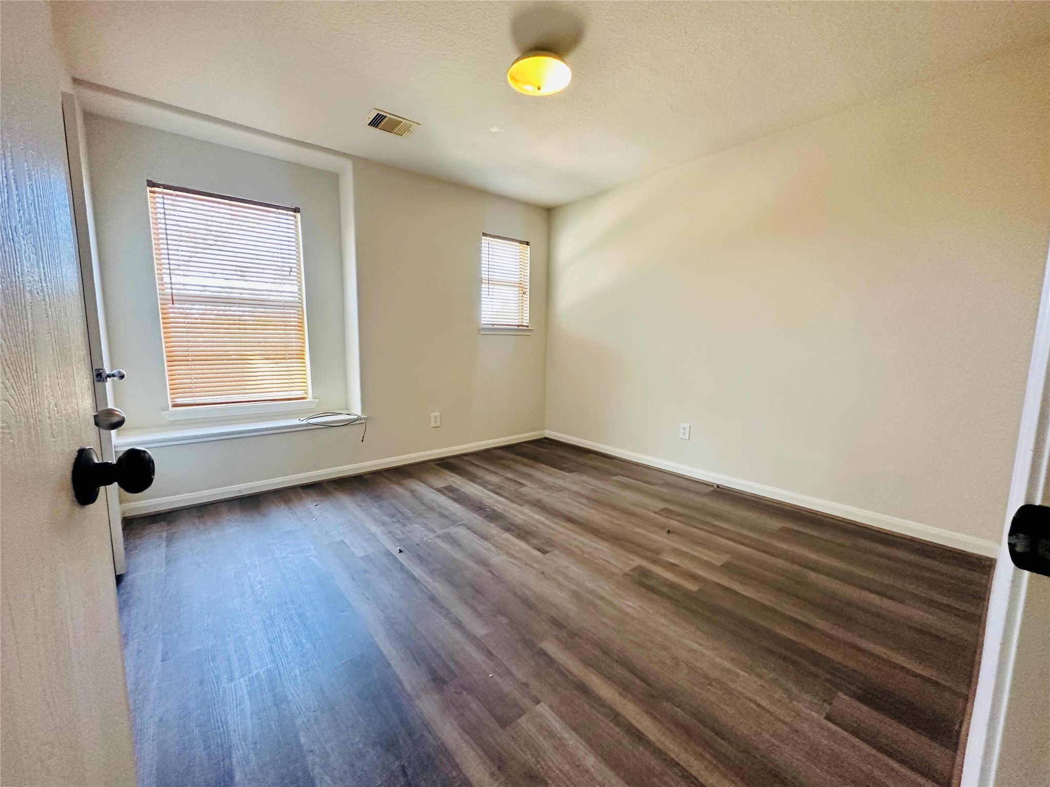 6602 Providence View Lane Houston, TX 77049 - Photo 9 of 17 an empty room with wooden floor and windows