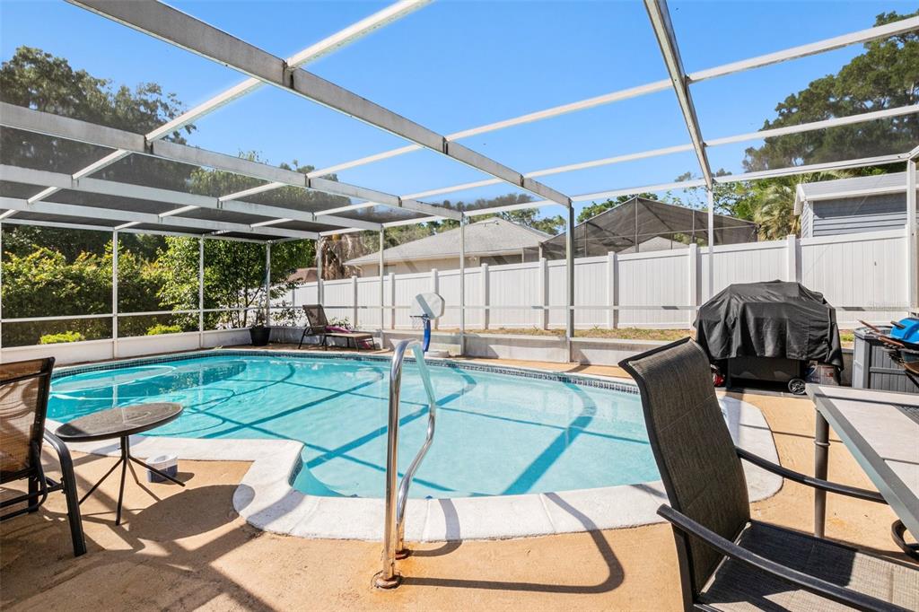 210 Red Rose Lane Inverness, FL 34452 - Photo 12 of 14 a view of a swimming pool with a patio