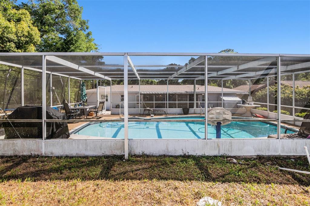 210 Red Rose Lane Inverness, FL 34452 - Photo 13 of 14 a view of a backyard with wooden fence
