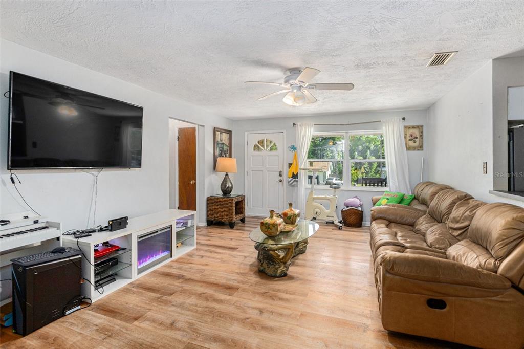 210 Red Rose Lane Inverness, FL 34452 - Photo 3 of 14 a living room with furniture and a flat screen tv