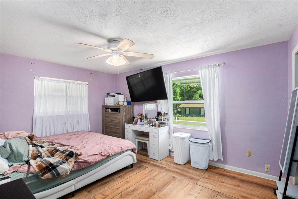 210 Red Rose Lane Inverness, FL 34452 - Photo 7 of 14 a bedroom with a bed flat screen tv and a window