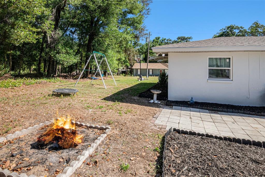 210 Red Rose Lane Inverness, FL 34452 - Photo 10 of 14 a backyard of a house with trees