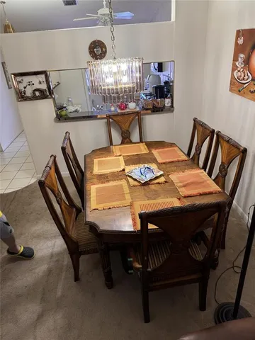 a kitchen with a table chairs and a wooden floor