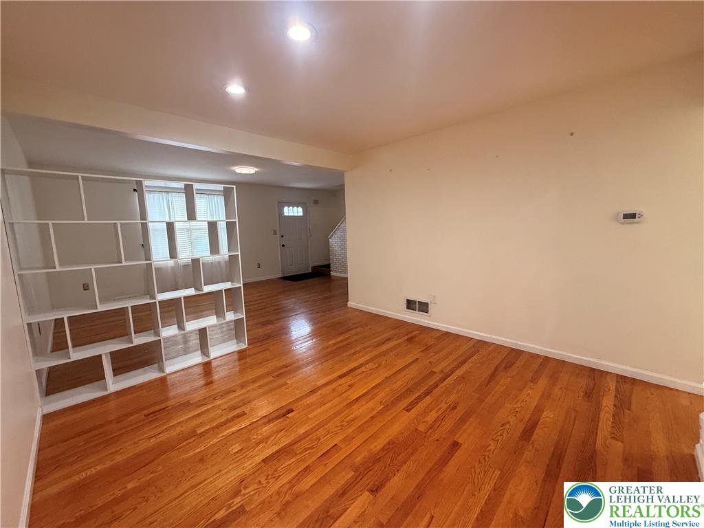 170 Springhouse Road Allentown, PA 18104 - Photo 6 of 23 Hardwood floors stretch across this inviting living room, ready for personalization.