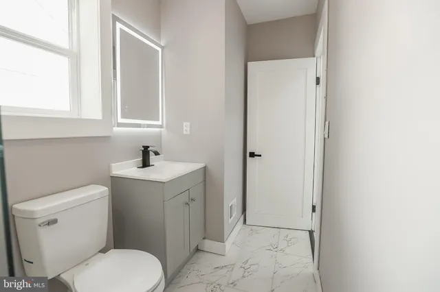 a bathroom with a sink toilet and vanity